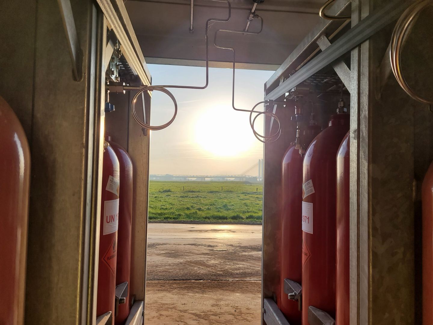 Gas cylinders in a Powercrumbs unit, overlooking the field at sunset